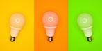 Three light bulbs on yellow, orange and green backgrounds